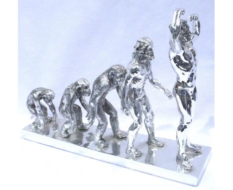 Cast resin silvered, evolution of man figural group, L: 30 cm. P&amp;P Group 2 (£18+VAT for the first lot and £3+VAT for subs