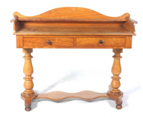 A Victorian satin birch wash standHaving a tray top with a single shelf above a pair of frieze drawers each applied with turn