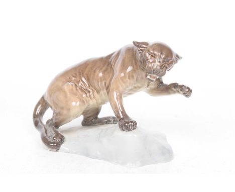 A Beswick Puma on a rock figureRealistically modelled, glazed in brown and grey gloss tones, impressed model no: 1823, 15cm h