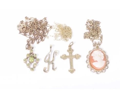 A peridot pendant and chainIn 9k gold, together with, a 9k gold cameo pendant and chain, a 9k gold 'K' pendant and a 9k gold 
