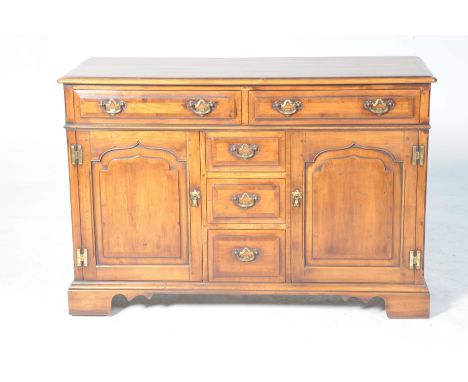 A good quality reproduction Georgian style cherry wood sideboard dresser by Simpsons of NorfolkThe rectangular moulded and cr