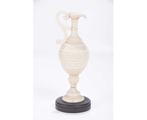 A carved North Indian model of a ewer, circa 1900The amphora vessel with scroll loop handle, extensively carved to the exteri