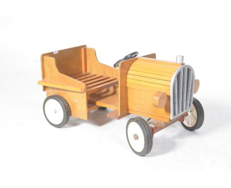 A child's wooden model car Modelled as a cruiser with slatted seat and wheels, 83cm long.