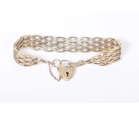 A yellow metal gate-link braceletWith a 9k gold heart padlock, weight approx. 30.5g