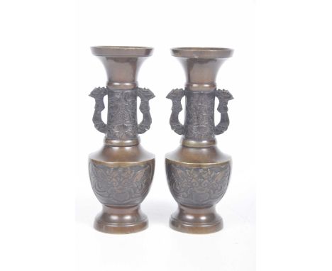 A pair of Japanese bronze vases, Meiji periodEach of baluster form rising from a domed foot flanked by stylized Phoenix twin 