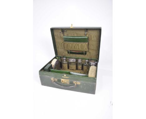 A early 20th Century Mappin & Webb gentleman's travelling caseThe green leather hinged case enclosing various silver topped b