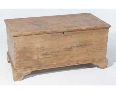 A Victorian pine blanket chestThe rectangular hinged cover enclosing a fitted candle box, raised upon bracket feet, 101x48x52