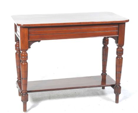 A Victorian mahogany side tableThe rectangular top with rounded corners raised upon ring turned and ring incised tapering leg