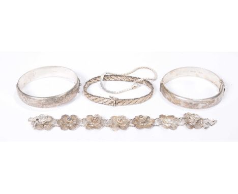 Two silver banglesTogether with, a white metal filigree bracelet, and two white metal bracelets (5)