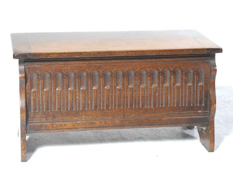 A 17th Century style oak coffer of small proportions Having a rectangular cleated top above a chiseled front panel, raised on