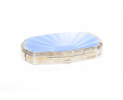 A silver and enamel powder compactOf shaped rectangular form, the blue guilloche enamel applied to a scalloped engine turned 