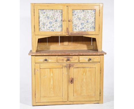 A late 19th Century stained and scumbled hardwood kitchen dresserThe upper section with a pair of glazed doors lined with fol