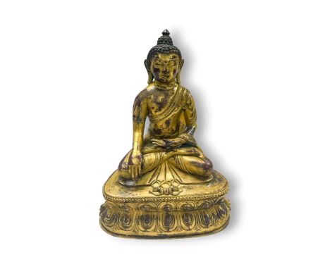 A Chinese gilt bronze figure of Shakyamuni, 20th century, seated in meditation, on a double lotus dais23cm high