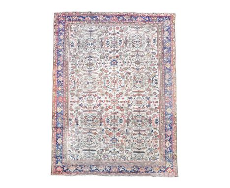 A Herat carpet, with stylised florals, on an ivory ground and mainly blue border348 x 246cmPile generally low but all intact 