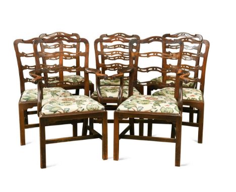 A set of eight George III style mahogany ladder back dining chairs, to include two carvers, with needle point tapestry drop i
