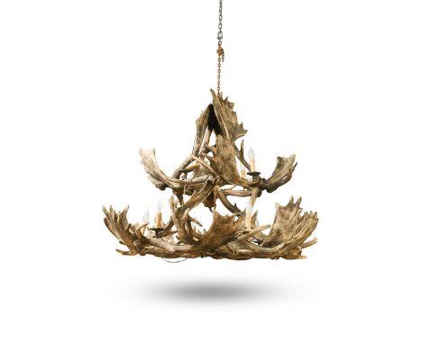 A large faux antler ten light chandelier, 20th century, in the Bavarian style, of conical form with two tiers of overlapping 