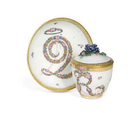 A Nymphenburg covered cup and saucer circa 1780, painted with floral garlands with the letter R to the cup, and the number 2 