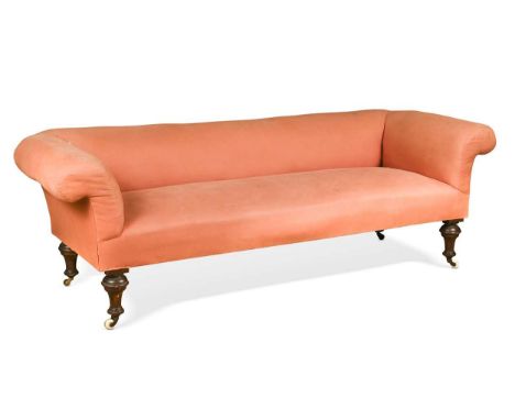 An Edwardian Country House three seat sofa,  upholstered in a light pink fabric, the turned legs with ceramic and brass casto
