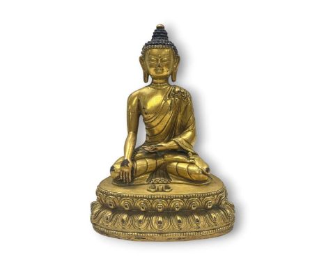 A Chinese gilt bronze seated figure of Buddha, 20th century, with tightly curled hair and wisdom dome, on a lotus throne22cm 