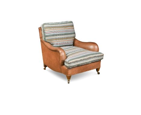 An Edwardian leather upholstered mahogany club armchair, the rectangular back and arms upholstered in a brown leather with st