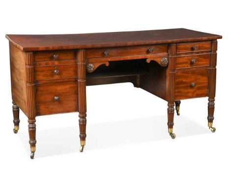 A William IV mahogany kneehole dressing table, in the manner of Gillows, comprising of seven drawers around a central kneehol