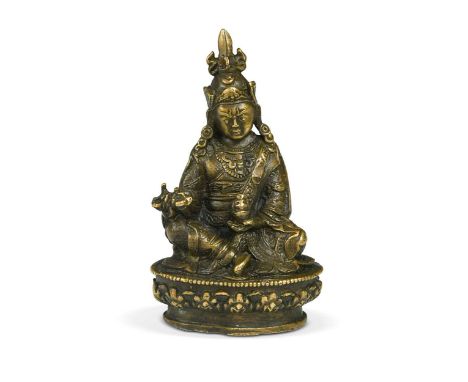 A Tibetan gilt bronze small figure of the Buddhist Tantric Vajra Master Padmasambhava, late 19th/early 20th century, seated h