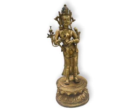 A Tibetan style gilt bronze standing Tara, 20th century, wearing a crown and robes, on a double lotus base48cm high overall