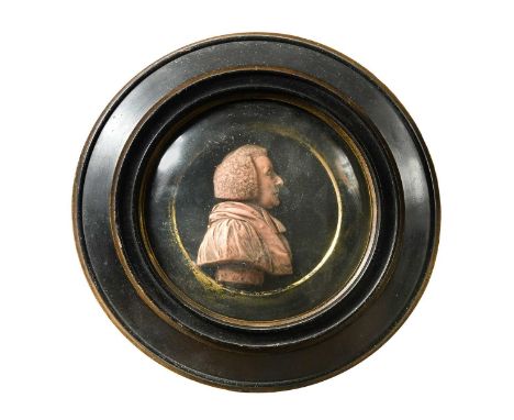 A wax portrait relief of Isaac Watts, 19th century, in side profile, 9.5cm high, in a circular ebonised frame with convex gla