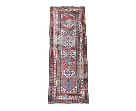 A Karaja tribal runner rug, circa 1900, with a bold geometric design in madder, pale indigo and ivory334 x 107cm