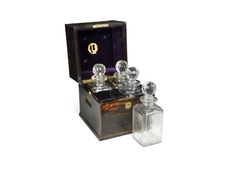 A Victorian coromandel decanter box, the fitted interior with four glass decanters, flush fitting brass carrying handles to e