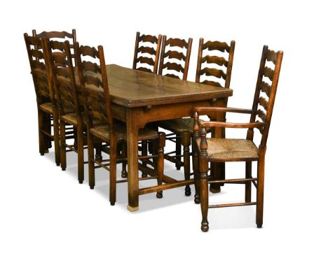 A set of twelve oak wavy-ladder back dining chairs, 18th century style, including two armchairs, with rush seats on turned le