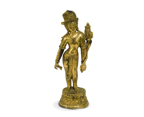 A Tibetan gilt bronze standing figure of Padmapani, 17th century, with turquoise inset crown and holding a lotus stem in her 