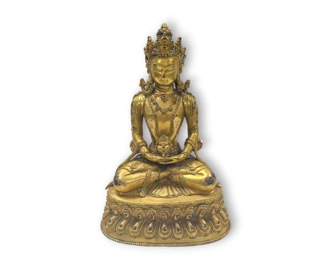 A Chinese gilt bronze Amitayus, 20th century, seated in meditation on a double lotus base23cm high