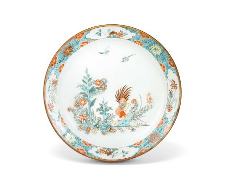 A Chinese Kakiemon porcelain plate, Qianlong, decorated with a rooster in a garden with birds, within a blue ground border wi