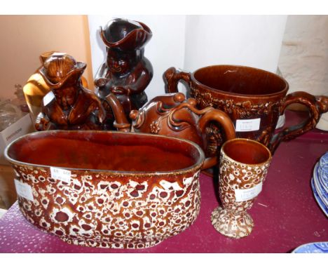 A Spode teacle glazed Cadogan teapot with restoration to spout, two similar Toby jugs, and a large loving cup - sold with two