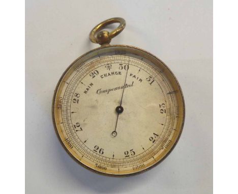 An antique brass pocket barometer with silvered dial