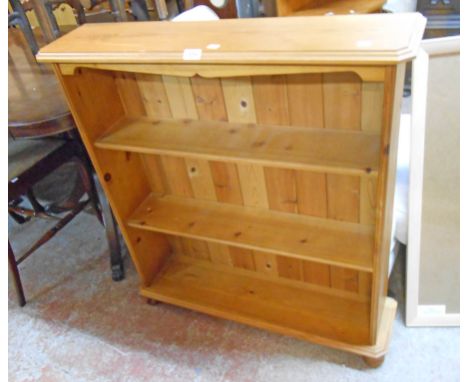 A 34 1/2" modern waxed pine three shelf open bookcase, set on turned feet