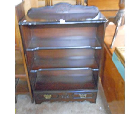 A 31" antique style dark stained wood and ebonised three shelf open bookcase with drawer under, set on bracket base