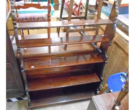 A 36" Victorian style stained wood five shelf open waterfall bookcase, set on a acanbus scroll standard ends and bun feet