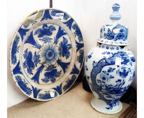 An 18th Century Delft ware jar and cover decorated in the chinoiserie style with a lady holding a basket of fruit - sold with