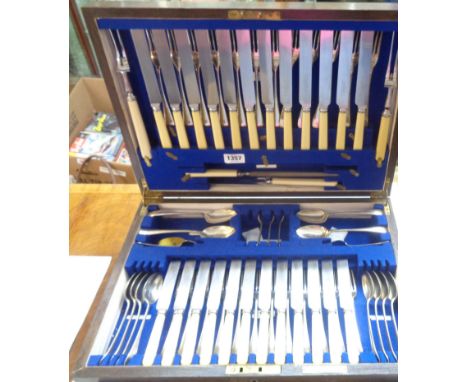 A vintage oak drawer fitted canteen containing an almost complete set of mainly Rogers silver plated cutlery