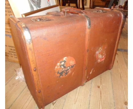 A vintage wood bound and weather coated Dura suitcase