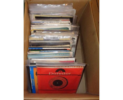 A box containing a quantity of vinyl 45rpm singles including Jilted John, The Beatles, Rolling Stones, The Clash, Pelican Dub