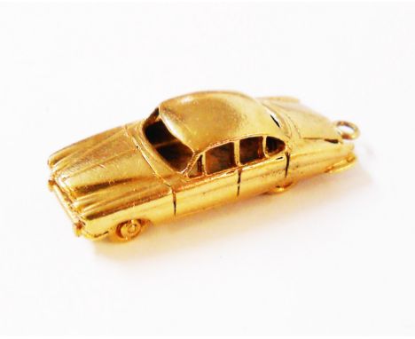 A hallmarked 9ct. gold charm in the form of a jaguar mark 10 automobile by QK Ltd.