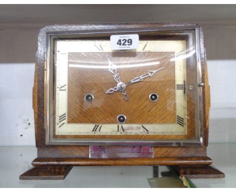 A 1930's polished oak cased mantel clock with Enfield eight day gong striking movement - presentation plaque to front
