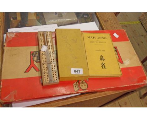 A vintage Monopoly game, Mah Jong card game with counters and book, and cribbage board