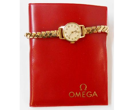 A vintage 9ct. gold cased lady's Omega wristwatch on replacement Montal rolled gold expanding bracelet - complete with wallet