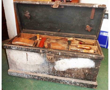 A vintage carpenter's tool box with contents