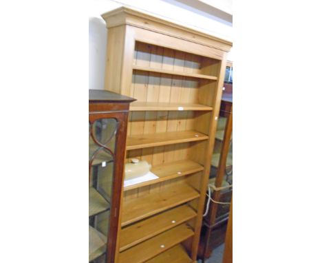 A 3' 3 1/2" waxed pine eight shelf open bookcase, set on plinth base - 7' 2 1/4" high