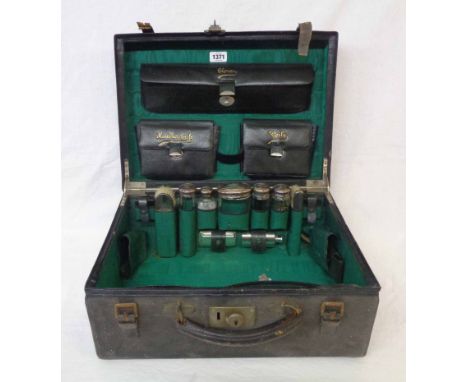 An early 20th Century leather travelling toilet case containing five original silver topped jars bearing monograms - London 1